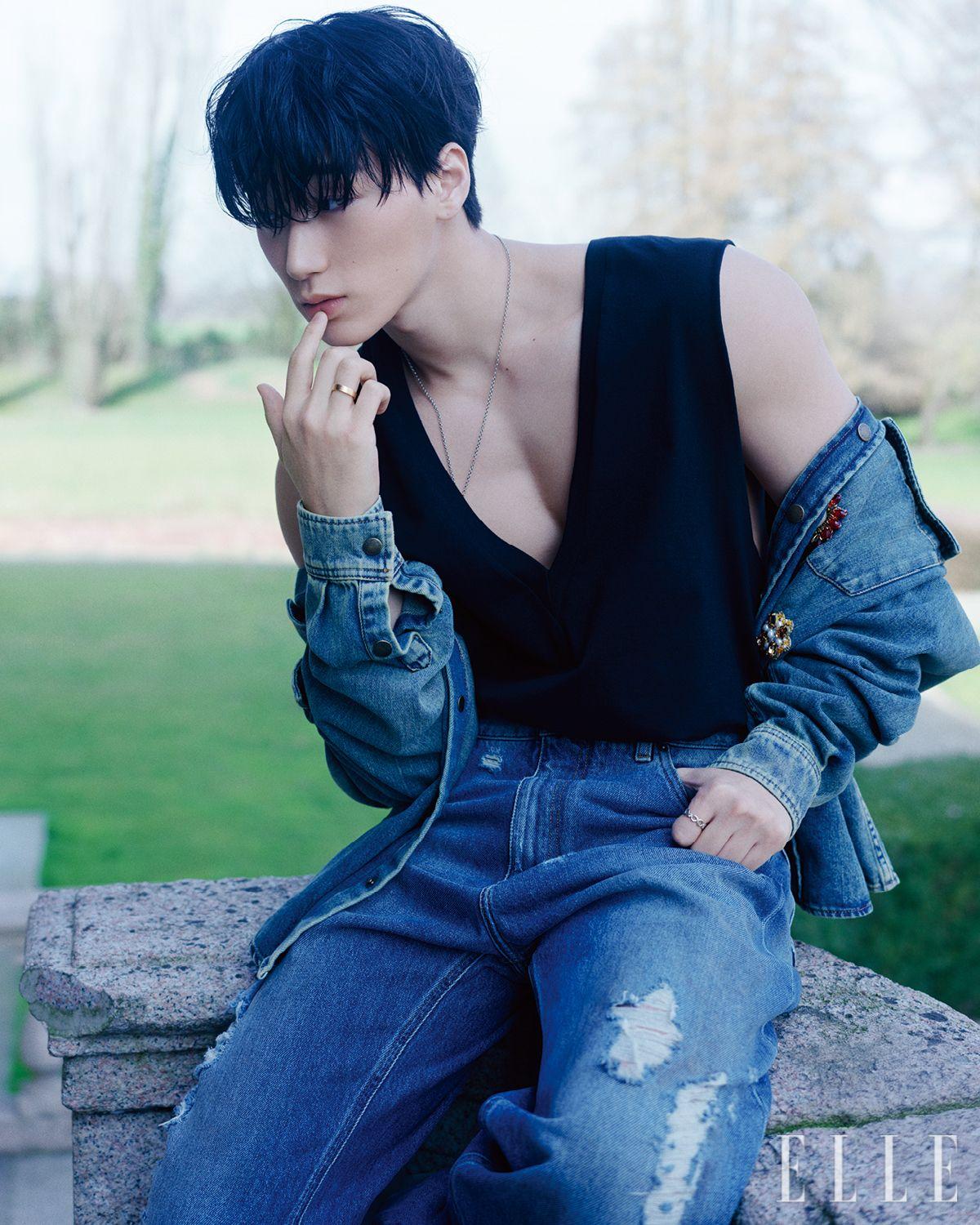 산이 입은 아플리케 데님 셔츠와 슬리브리스 톱, 데님 팬츠, 네크리스는 모두 Dolce & Gabbana.