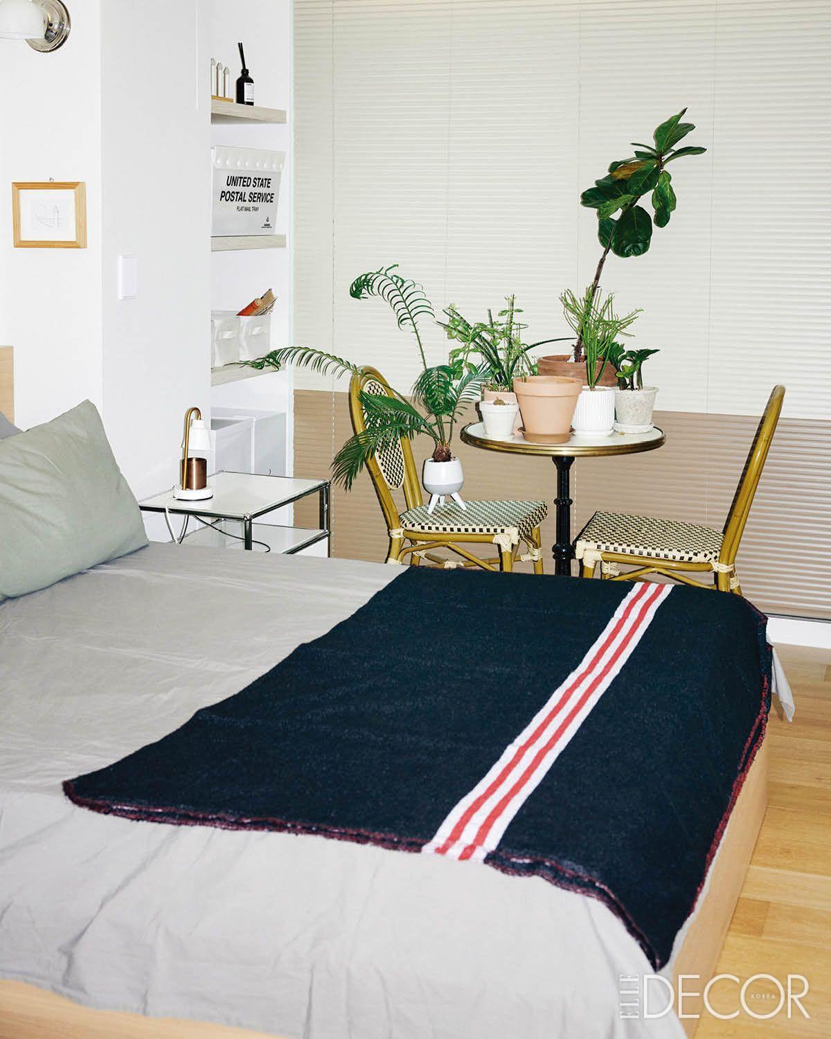 침실. 창가의 블라인드를 열면 환한 빛이 쏟아진다. 이사 오기 전부터 사용하던 빈티지 테이블과 의자는 화분들의 차지가 됐다.