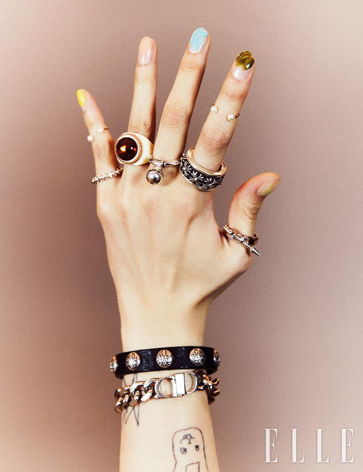 왼손 마디에 낀 진주 장식의 피어스 링은 Gneul. 새끼손가락에 낀 링은 Trencadism. 약지에 낀 링은 Usite X Amonz. 중지에 낀 링은 207 Tribe. 검지에 낀 링은 Chrome Hearts. 엄지에 낀 링은 Ille Lan. 레더 브레이슬렛은 Chrome Hearts. 체인 브레이슬렛은 Dior. 